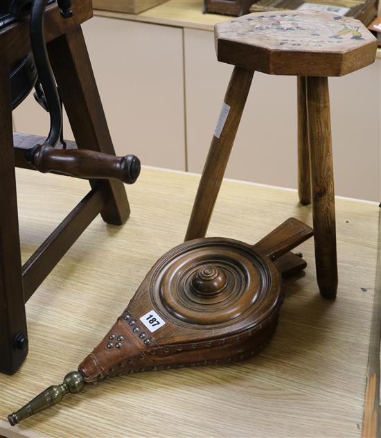 A pair of bellows and a stool